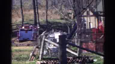 Wauconda Illinois USA (1968): Fire Truck Drives By The Yard Which Appears Full Of