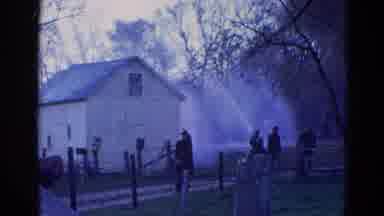 Wauconda Illinois USA (1968): Fireman Spraying Water On A Building That Is On Fire