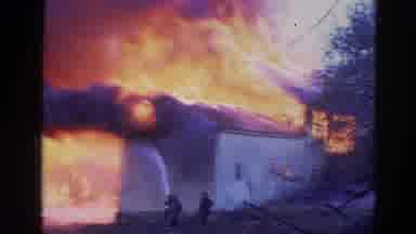 Wauconda Illinois USA (1968): Lone Firefighter Battles Fire Ravaging Building As