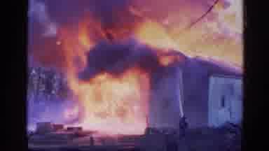 Wauconda Illinois USA (1968): Fireman Fighting Wild Burning House With Blazing Red