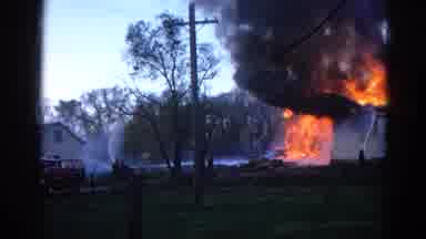 Wauconda Illinois USA (1968): White House Is Burning And Fireman Tries To Put Out