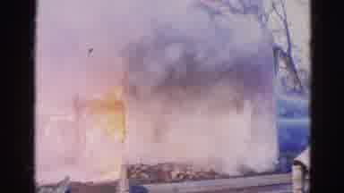 Wauconda Illinois USA (1968): People Offscreen Putting Out House Fire On A Clear