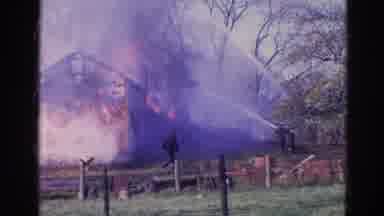 Wauconda Illinois USA (1968): Two Firefighters Using Hoses To Put Out The Fire In