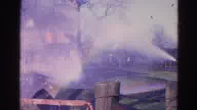 Wauconda Illinois USA (1968): Firefighters Trying To Put Out A Burning House