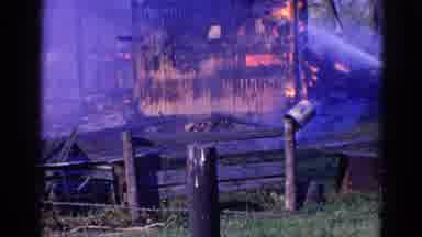 Wauconda Illinois USA (1968): Water Is Being Sprayed On A Building As It Burns And