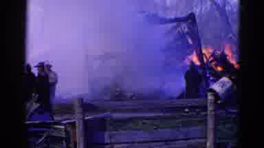 Wauconda Illinois USA (1968): A Group Of Firefighters Gather Around A Burning