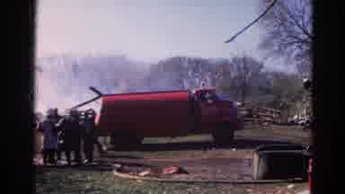 Wauconda Illinois USA (1968): Fire Brigade Men Put Out House Fire With Truck