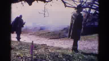 Wauconda Illinois USA (1968): Man Carrying A Coat Walks Toward Another Larger Man