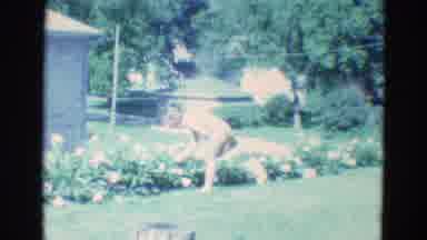 Diller Nebraska (1969): Woman Smelling Flowers In A Green Yard
