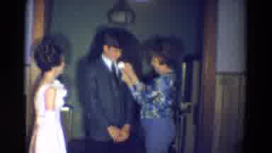 Diller Nebraska (1969): Woman Pinning A Boutonniere Onto A Young Man Wearing A