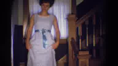 Diller Nebraska (1969): Woman Wearing A White Dress Walking Down A Flight Of