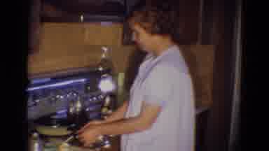 Diller Nebraska (1969): Woman In White Gown Cooking And Preparing Eggs On Stove