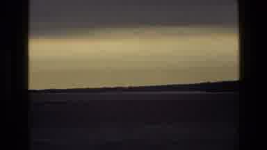 England (1969): Landscape Of Hazy Sky And Large Field And Cars Stuck In Traffic