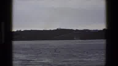 England (1969): Large Body Of Water In The Foreground Camera Zooms In To Reveal