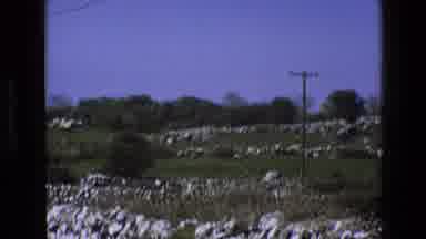 England (1969): A Rocky Hillside With Blue Sky Trees And Telephone Poles