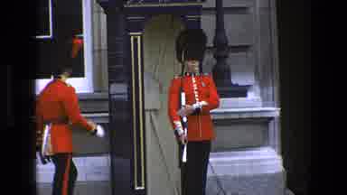 England (1969): British Soldiers Talking To Another Soldier In Front Of A Building