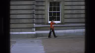 England (1969): Russian Soldier Marching Wearing A Tall Black Hat Protecting His