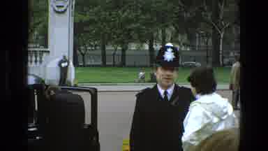 England (1969): British Bobby Talking With A White Coated Person