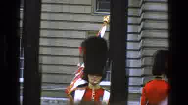 England (1969): London Guard Carrying A Flag Marching Towards People Standing
