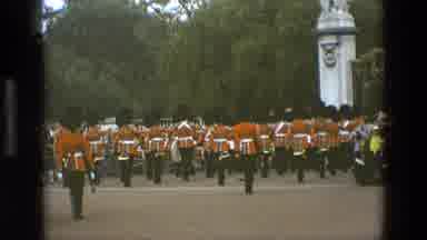 England (1969): Large Group Of British Soldiers Marching Holding Flags And Also
