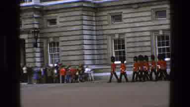 England (1969): Onlookers Watch The Queen's Guard March In Formation In A Parade