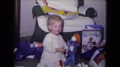 Fort Wayne Indiana (1969): A Young Child Examines A Toy Doll After Unwrapping