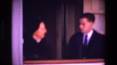 Ireland-1969: Two People Talking In A Room With White Walls