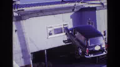 Ireland (1969): An Old Black Car Being Moved By A Crane While A Man Is Looking At