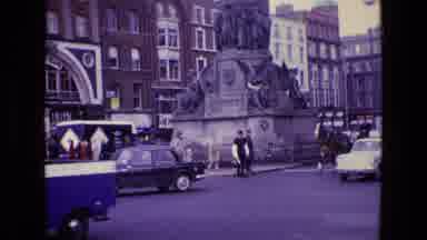Ireland (1969): Cars And A Horse Carriage Pass By A Busy Intersection Of A City