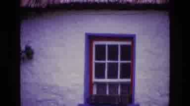 Ireland (1969): Red And Blue Painted Window Frame Of A Building With A Straw Roof