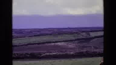 Ireland (1969): A Brown And Green Field On A Party Cloudy Day With Grayish Skies