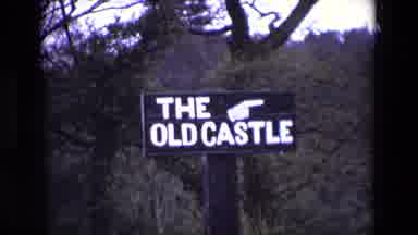 Ireland (1969): Road Sign And People Heading Towards The Old Castle