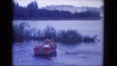 Lake Canyon Arizona (1969): Two People In A Row Boat Head Towards The Grasses And