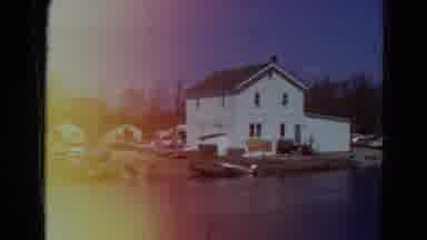 Minnesota USA (1969): Filming Of A House Near Water With Junk Cars Behind It