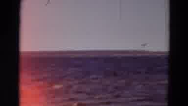 Minnesota USA (1969): Footage Of Lapping Ocean Waves Transitions To Woman Standing