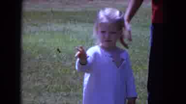 White Sands Florida-1970: Young Girl Plays Near Street Sign With Adult