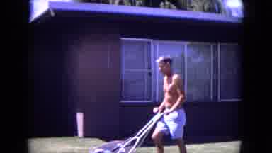 White Sands Florida (1970): A Man Wearing Shorts Mowing The Lawn With Lawn Mower