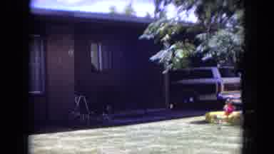 White Sands Florida (1970): Shirtless Man Pushing A Lawnmower In His Front Yard