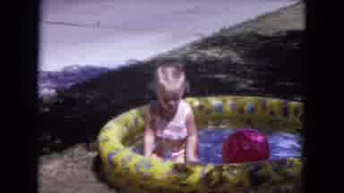 White Sands Florida (1970): Toddler Wearing Pink Swimwear Plays In Yellow Kiddie