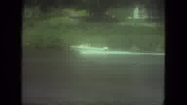 Mississippi (1971): Boat Riding Fast In Water Along Shore With Grass And Trees