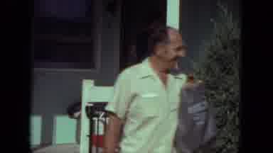 Mississippi (1971): Man Walking Down Stairs With Shopping Bag And People Gathered