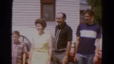 Diller Nebraska USA (1968): Two Families Standing In Front Of A Red Open Top
