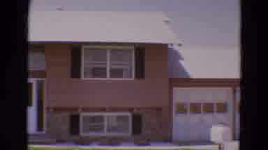 DILLER NEBRASKA USA-1968: The Pink-Sided House As Camera Pans Across Suburban Home