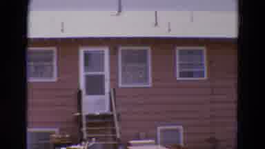 Diller Nebraska USA (1968): A Modest Brown House Is Shown With Many Windows And A