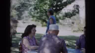 Clarksdale Arizona (1968): People Sitting Outside Around A Table While A Woman
