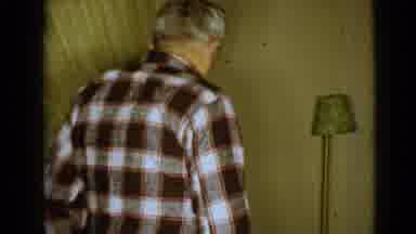 Clarksdale Arizona (1968): Elderly Man Wearing Plaid Shirt Slowly Walking To Sit