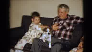Clarksdale Arizona (1968): Boy Pets Dog As It Sits On Older Man's Lap And Woman