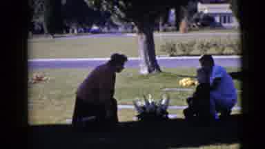 Clarksdale Arizona (1968): A Family Is At A Cemetery Kneeling Down Praying At A