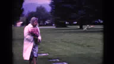 Clarksdale Arizona (1968): Woman Wearing Glasses With Long White Coat Walking In