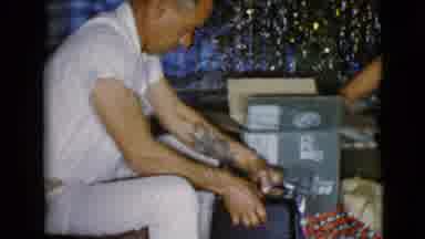 Clarksdale Arizona USA (1968): Dad Is Opening A Christmas Present For His Curious